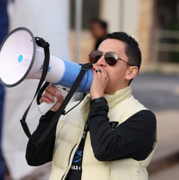 Angel with a megaphone directing runners